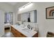 Bathroom vanity with double sinks and an illuminated mirror at 922 Cottage Ave, Indianapolis, IN 46203