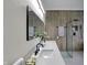 Modern bathroom with double sinks, walk-in shower, and wood-look tile at 922 Cottage Ave, Indianapolis, IN 46203