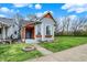 Inviting home featuring blue door, gray siding, green lawn, and lovely window boxes at 922 Cottage Ave, Indianapolis, IN 46203