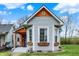 Charming home with gray siding, flower-filled window boxes and striking architectural details at 922 Cottage Ave, Indianapolis, IN 46203