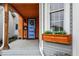 Front porch with wood ceiling, blue door and flower-filled window box at 922 Cottage Ave, Indianapolis, IN 46203