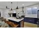Modern kitchen featuring an island with seating, stainless steel appliances, and pendant lighting at 922 Cottage Ave, Indianapolis, IN 46203
