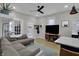 Open concept living space with modern lighting, grey sofa and black TV at 922 Cottage Ave, Indianapolis, IN 46203