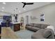 Bright living room area with adjacent kitchen area and grey sectional sofa at 922 Cottage Ave, Indianapolis, IN 46203