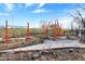 Colorful community playground equipment being installed, set in a gravel and dirt landscape at 922 Cottage Ave, Indianapolis, IN 46203