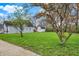 Front yard with trees and lush green grass surrounding the house at 922 Cottage Ave, Indianapolis, IN 46203