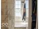 Bright bathroom featuring a walk-in shower, large window, and neutral color palette at 10105 Yosemite Ln, Indianapolis, IN 46234
