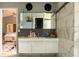 Modern bathroom featuring sleek white vanity with storage and tile accent wall at 10105 Yosemite Ln, Indianapolis, IN 46234