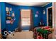 Colorful bedroom featuring bright walls, an eclectic mix of decor, and a window view at 10105 Yosemite Ln, Indianapolis, IN 46234