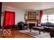 Elegant living room featuring a fireplace, ornate furniture, and decorative lighting at 10105 Yosemite Ln, Indianapolis, IN 46234