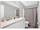 This bathroom has double sinks with white cabinetry and stone countertops at 10319 Pronghorn Ln, Indianapolis, IN 46239