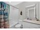 Bright bathroom with a shower-tub combo and a vanity with a white sink and modern fixtures at 10319 Pronghorn Ln, Indianapolis, IN 46239