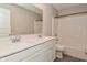 Bright bathroom with white cabinets, a shower-tub combo, and a double-sink vanity with a quartz countertop at 10319 Pronghorn Ln, Indianapolis, IN 46239