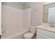 Bright bathroom with white cabinets, a soaking tub, and a single-sink vanity with a quartz countertop at 10319 Pronghorn Ln, Indianapolis, IN 46239
