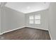 Empty bedroom with hardwood flooring, two windows, and fresh paint at 10319 Pronghorn Ln, Indianapolis, IN 46239