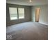 Large bedroom with neutral walls, plush carpeting, and natural light from two windows at 10319 Pronghorn Ln, Indianapolis, IN 46239