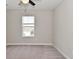 Spacious bedroom featuring a window with blinds, neutral paint, a ceiling fan, and plush carpeting at 10319 Pronghorn Ln, Indianapolis, IN 46239