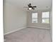 Spacious bedroom featuring two large windows with blinds, neutral paint, a ceiling fan, and plush carpeting at 10319 Pronghorn Ln, Indianapolis, IN 46239