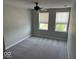 Cozy bedroom with two bright windows, plush carpet, and ceiling fan at 10319 Pronghorn Ln, Indianapolis, IN 46239