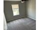 Bright bedroom with large window, plush carpet, and ceiling fan at 10319 Pronghorn Ln, Indianapolis, IN 46239