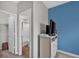 Bedroom featuring a blue accent wall, white dresser, and doorways leading to a bathroom and closet at 10319 Pronghorn Ln, Indianapolis, IN 46239