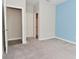 Bright bedroom with neutral tones, blue accent wall, and carpeted floors, showcasing a serene living space at 10319 Pronghorn Ln, Indianapolis, IN 46239