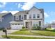 Charming two-story home with a well-manicured lawn, two-car garage and lovely landscaping at 10319 Pronghorn Ln, Indianapolis, IN 46239