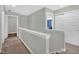 Upstairs hallway with neutral walls, carpeted floors, and access to multiple bedrooms at 10319 Pronghorn Ln, Indianapolis, IN 46239