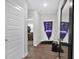 Inviting hallway with modern wood floors, with entry to a room and white front door at 10319 Pronghorn Ln, Indianapolis, IN 46239