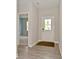 Hallway with neutral colors, hard wood flooring, and a bedroom and door to the exterior at 10319 Pronghorn Ln, Indianapolis, IN 46239