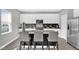 Modern kitchen featuring stainless steel appliances, white cabinets, and a center island with seating at 10319 Pronghorn Ln, Indianapolis, IN 46239