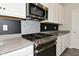 Elegant kitchen with a stainless steel gas range, microwave, and stylish backsplash at 10319 Pronghorn Ln, Indianapolis, IN 46239