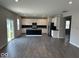 Bright, open-concept living room and kitchen with hardwood floors and plenty of natural light at 10319 Pronghorn Ln, Indianapolis, IN 46239