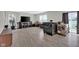 Living room featuring a large black leather sofa, exercise equipment, and hardwood floors at 10319 Pronghorn Ln, Indianapolis, IN 46239