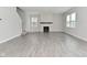 Open-concept living room with wood-look floors and a cozy fireplace, perfect for Gathering gatherings at 10319 Pronghorn Ln, Indianapolis, IN 46239
