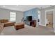 Comfortable living room with hardwood floors, a brown sofa, and an adjacent bathroom at 10319 Pronghorn Ln, Indianapolis, IN 46239