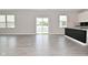 Spacious living room featuring hard wood floors, neutral walls, and a sliding door to the yard at 10319 Pronghorn Ln, Indianapolis, IN 46239