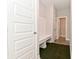 Hallway with a built in bench, coat hooks, hard wood flooring, and white accents at 10319 Pronghorn Ln, Indianapolis, IN 46239