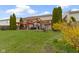 Spacious backyard features a patio, swing set, dining area, and green grass at 10955 Balfour Dr, Noblesville, IN 46060