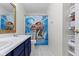 This bathroom features a double sink vanity, white tile floors and a Moana themed shower curtain at 10955 Balfour Dr, Noblesville, IN 46060