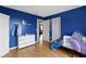 This bedroom features hardwood floors, blue walls and two closets at 10955 Balfour Dr, Noblesville, IN 46060