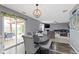 Open-concept dining area featuring hardwood floors and seamless connection to an outdoor living space at 10955 Balfour Dr, Noblesville, IN 46060