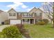 Charming two-story home with brick and vinyl siding, manicured lawn, and inviting front porch at 10955 Balfour Dr, Noblesville, IN 46060