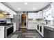 Well-lit kitchen features white cabinets, stainless steel appliances, and modern countertops at 10955 Balfour Dr, Noblesville, IN 46060