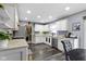 Bright kitchen boasts stainless steel appliances, wood floors, white cabinets, and granite countertops at 10955 Balfour Dr, Noblesville, IN 46060