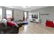 Inviting living room features hardwood flooring, large windows, and comfortable seating at 10955 Balfour Dr, Noblesville, IN 46060