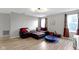 Bright living room with hardwood floors, a cozy couch, and plenty of natural light at 10955 Balfour Dr, Noblesville, IN 46060