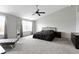 This primary bedroom boasts carpet floors, ample space, large windows and a ceiling fan at 10955 Balfour Dr, Noblesville, IN 46060