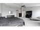 Spacious main bedroom features a ceiling fan, television, and closet space at 10955 Balfour Dr, Noblesville, IN 46060