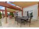 Covered patio with outdoor dining table and seating area at 10955 Balfour Dr, Noblesville, IN 46060
